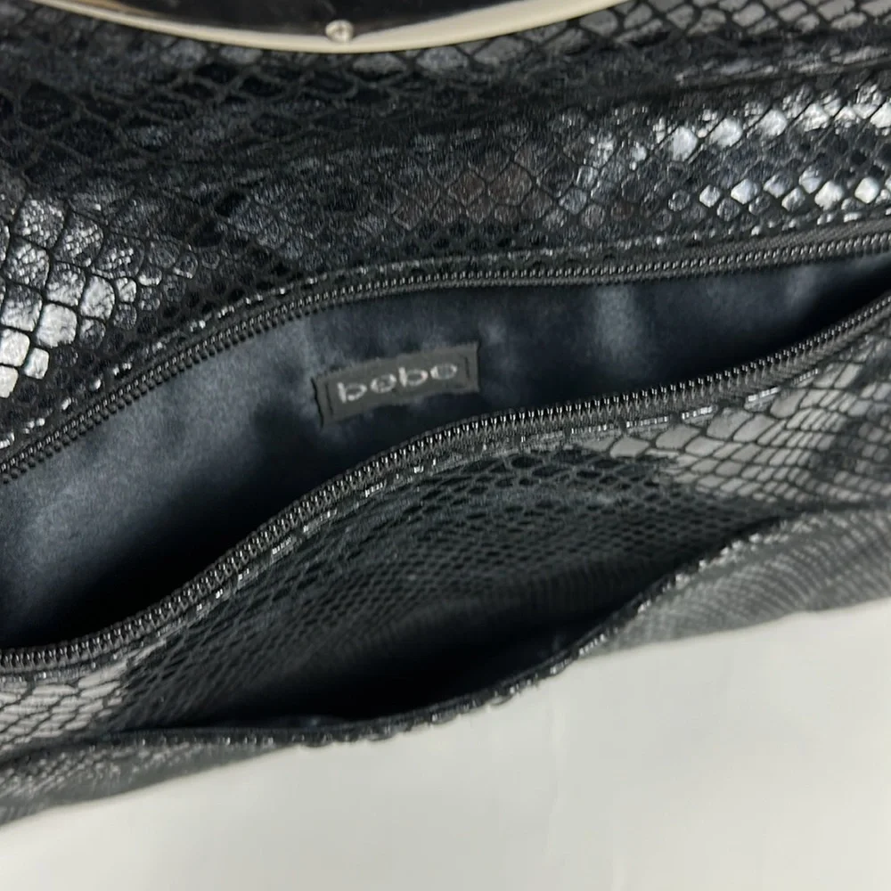 Bebe faux snake skin clutch with silver hardware
